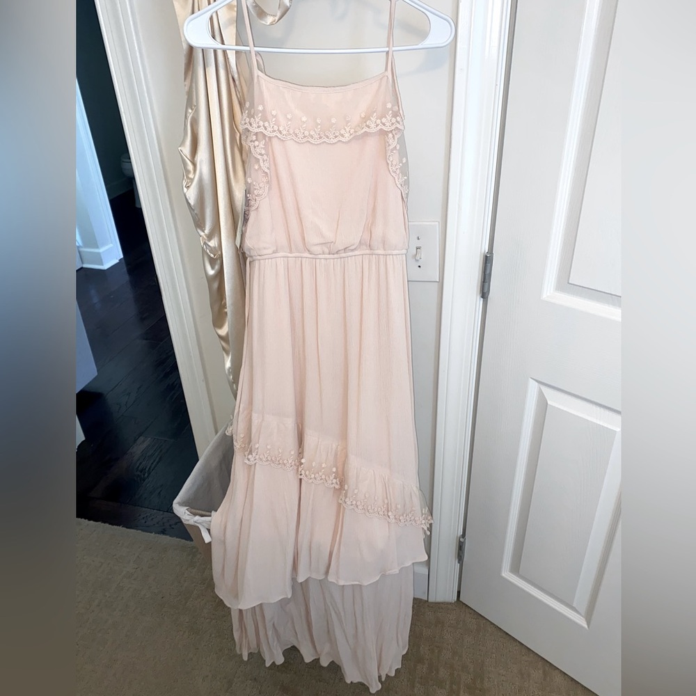 NWT (very light) pink girls dress size 16. It’s a soft gauzy material.